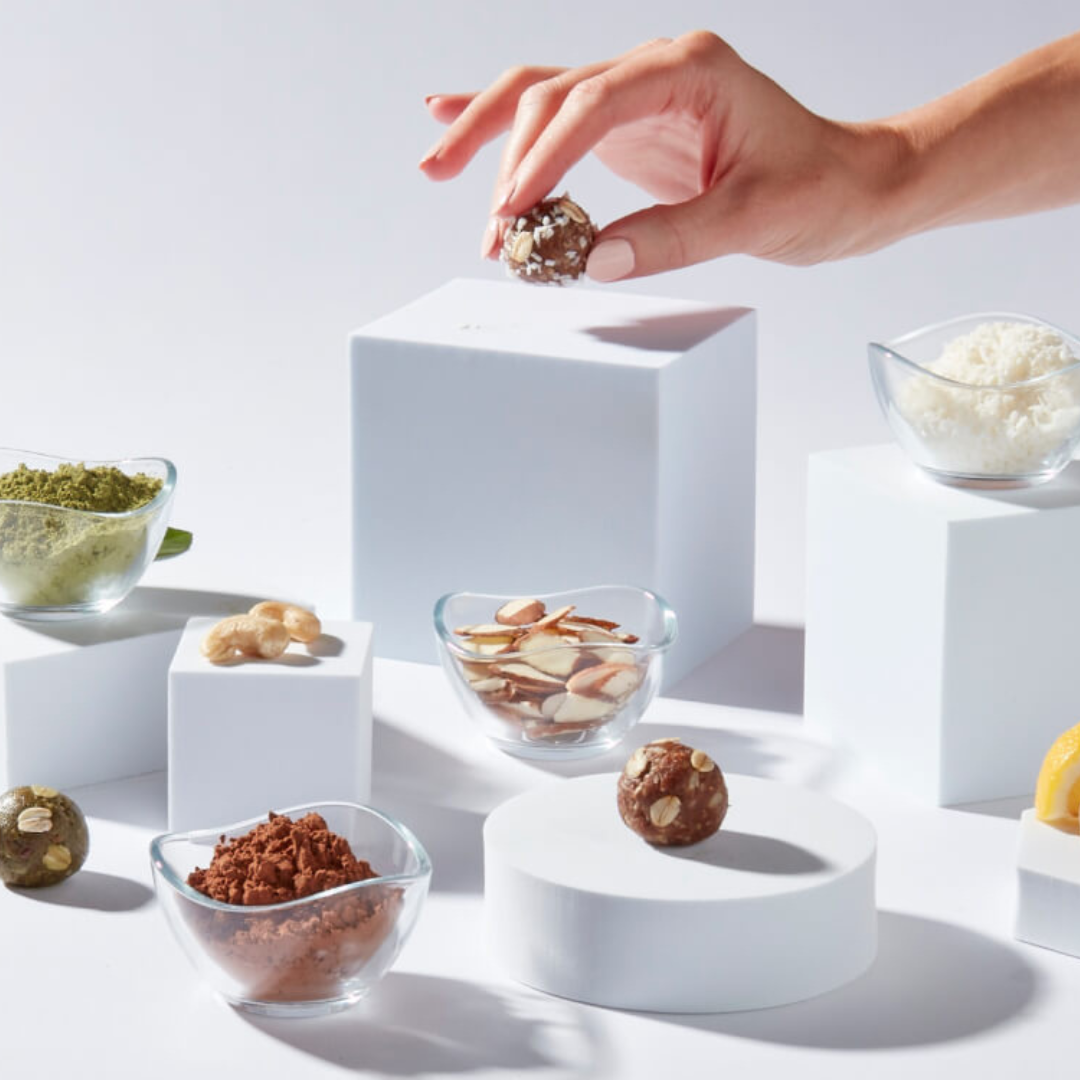 Hand picking up a Nunona mama bite to eat for maternal nutrition