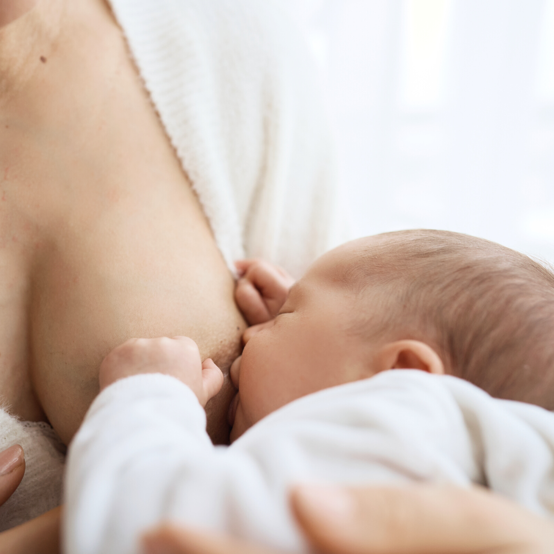 Mom breastfeeding baby in first 24 hours after birth